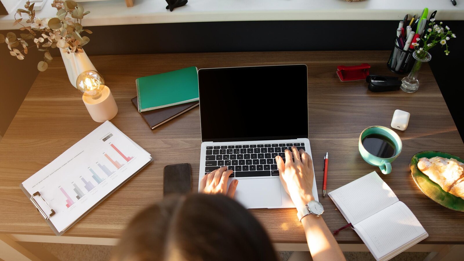 Student learning digital marketing at home with laptop analytics and notes