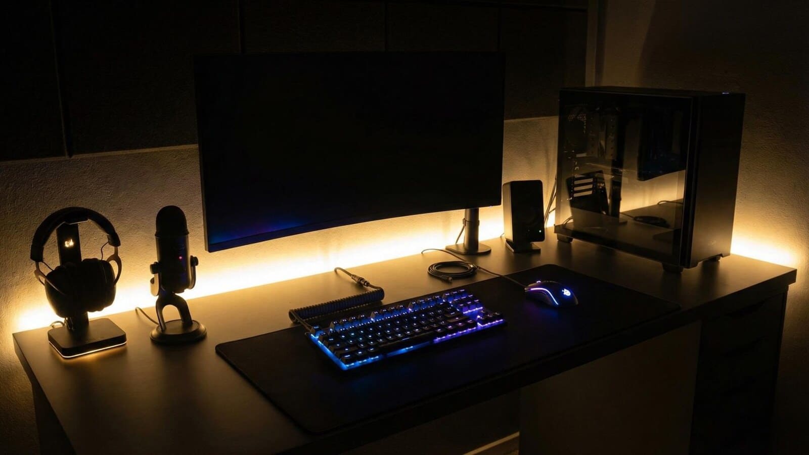 Gaming desk with monitor lighting and gear arranged for a long evening session