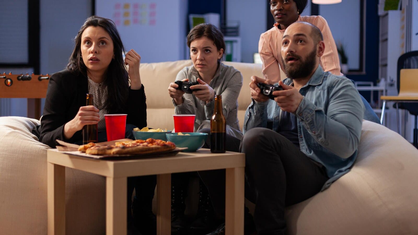 Game controllers and snacks on a table during a casual gaming night