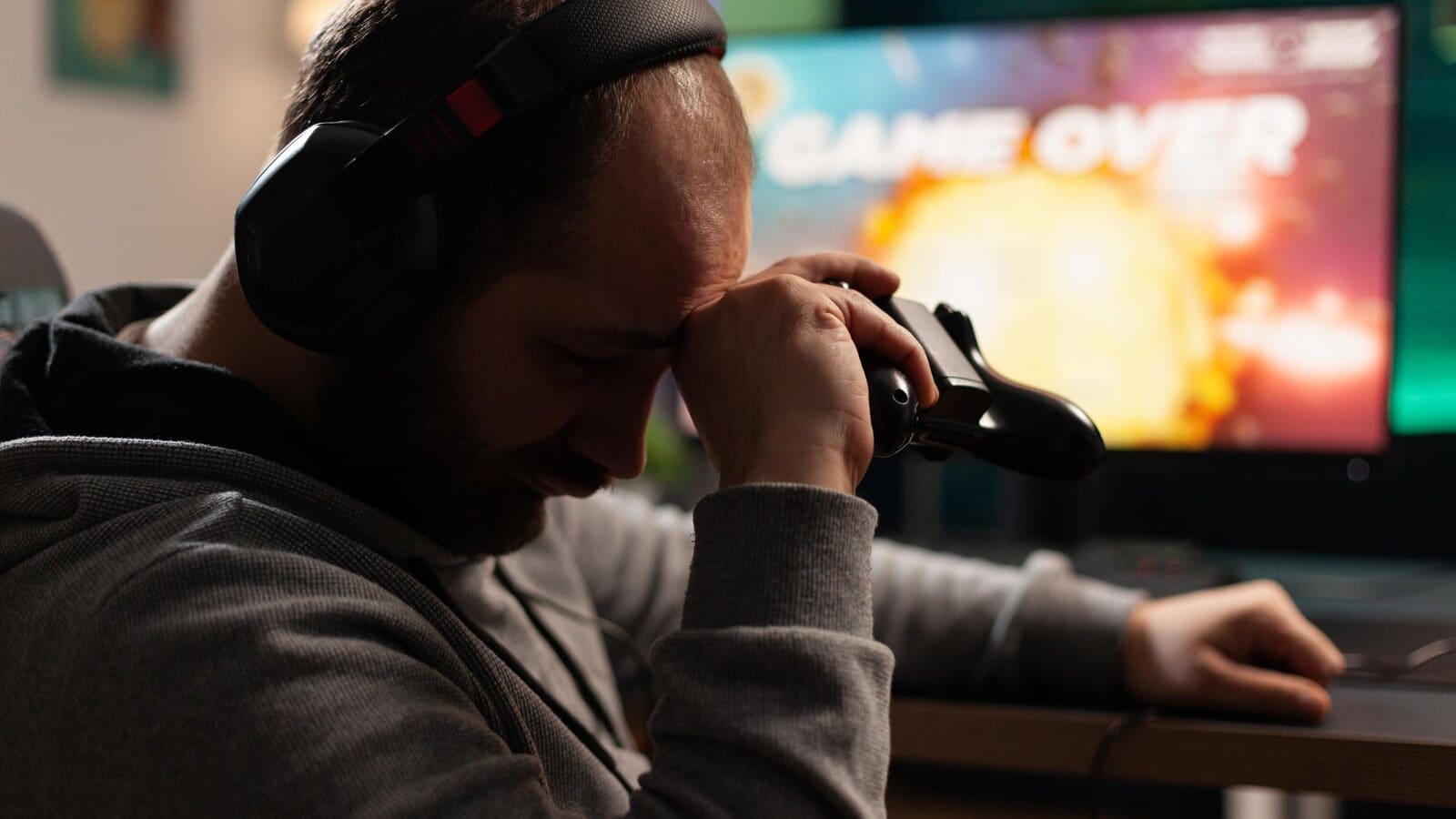 Gamer holding a controller while choosing settings on a screen
