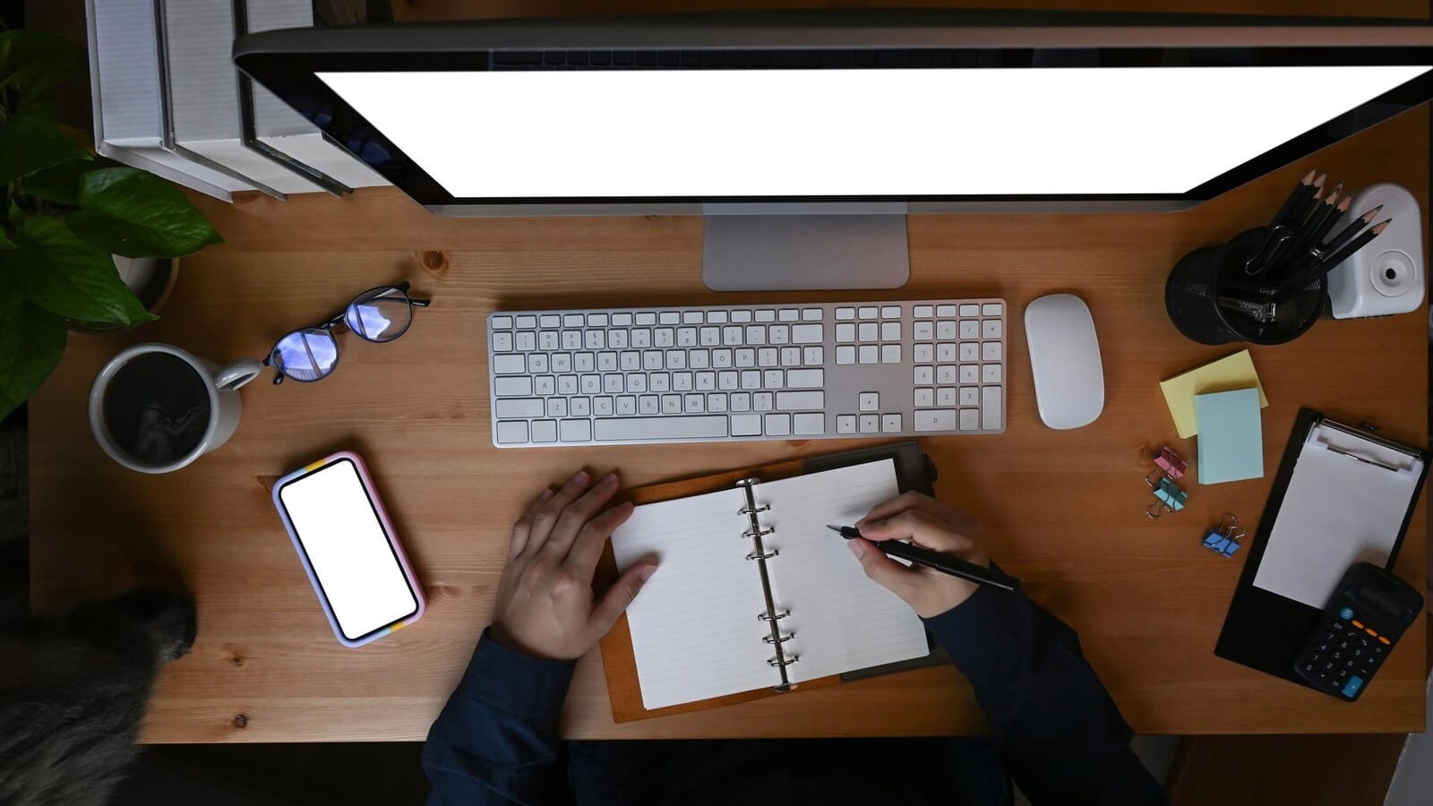 Laptop and notebook beside gaming gear for planning freelance services