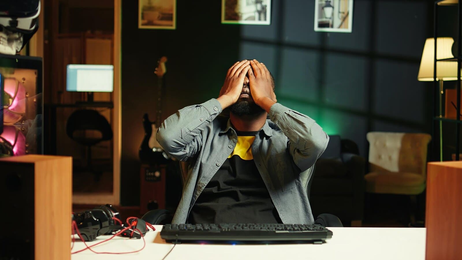 Frustrated gamer at a desk after losing an online match