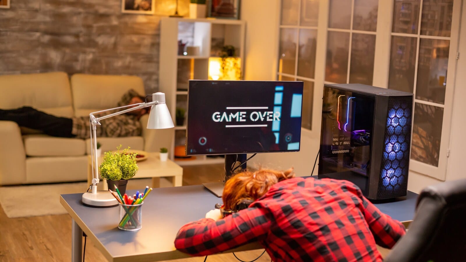 Gamer sitting alone at a desk during a late-night online match